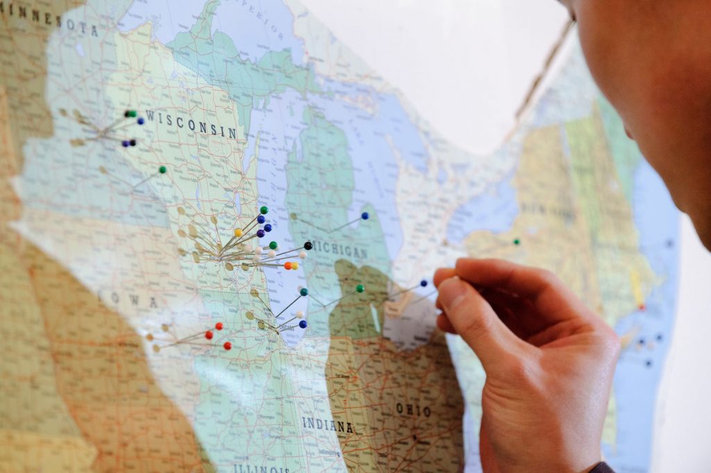 Sticking push pins in a map