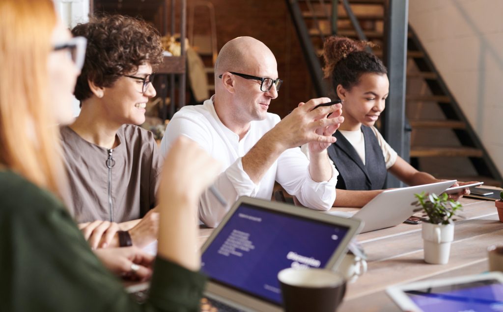 People at a table looking at their laptop screens